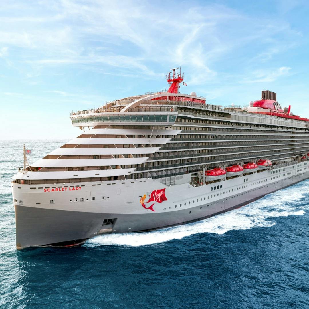 Virgin Voyages scarlet lady ship sailing with modern pool deck and red hammocks on balconies