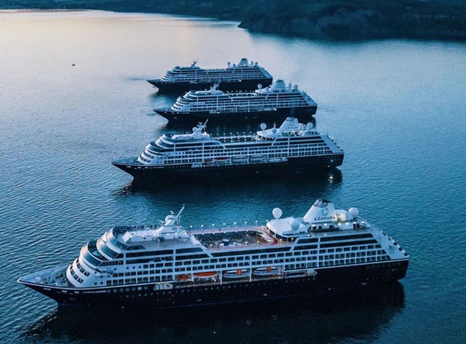 Azamara boutique cruise ship docked in a picturesque Mediterranean harbor at twilight
