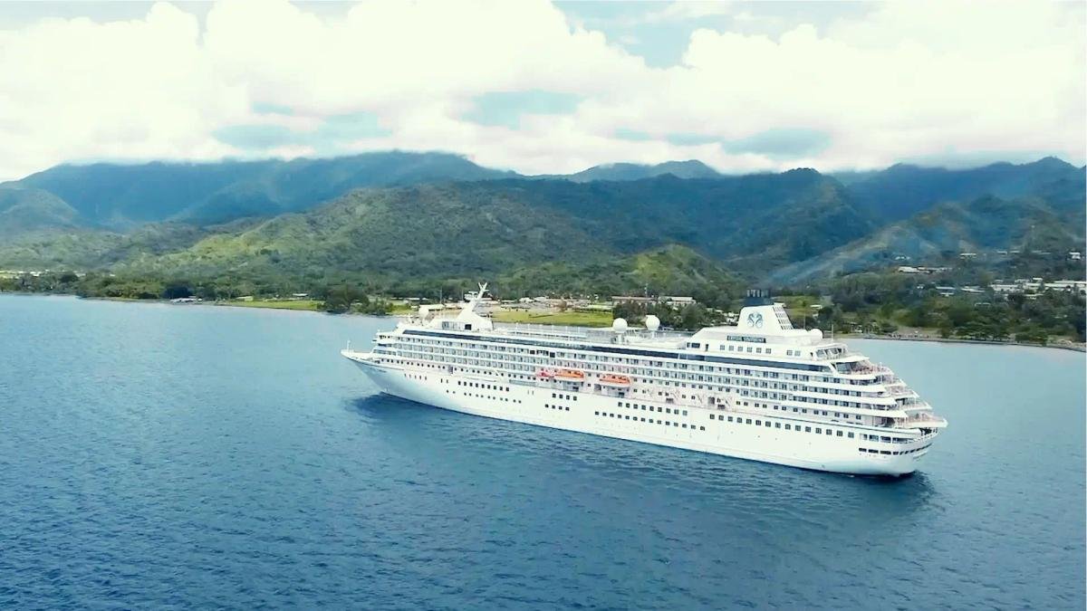 Crystal ultra-luxury cruise ship sailing peacefully along azure coastal waters